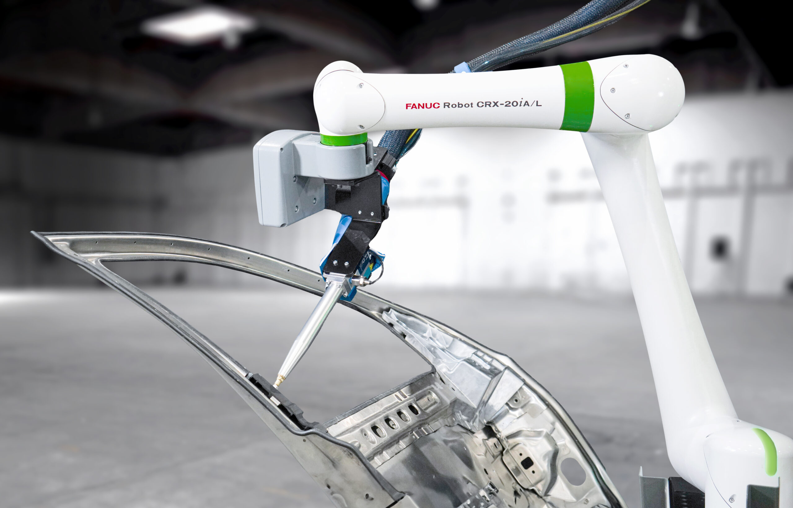 CRX-20iA/L collaborative robot dispensing and sealing a car door